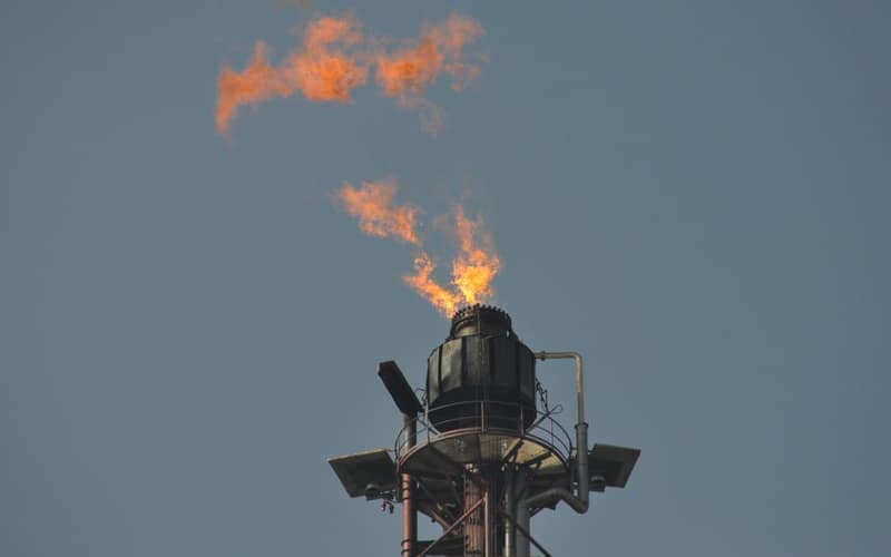 Flare stack releasing flames at an industrial site in Kerteh, Malaysia.
