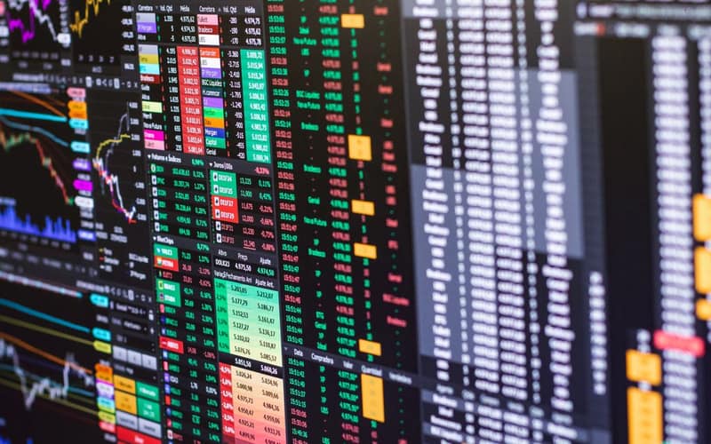 Detailed financial trading screen with colorful charts and data representing market fluctuations.