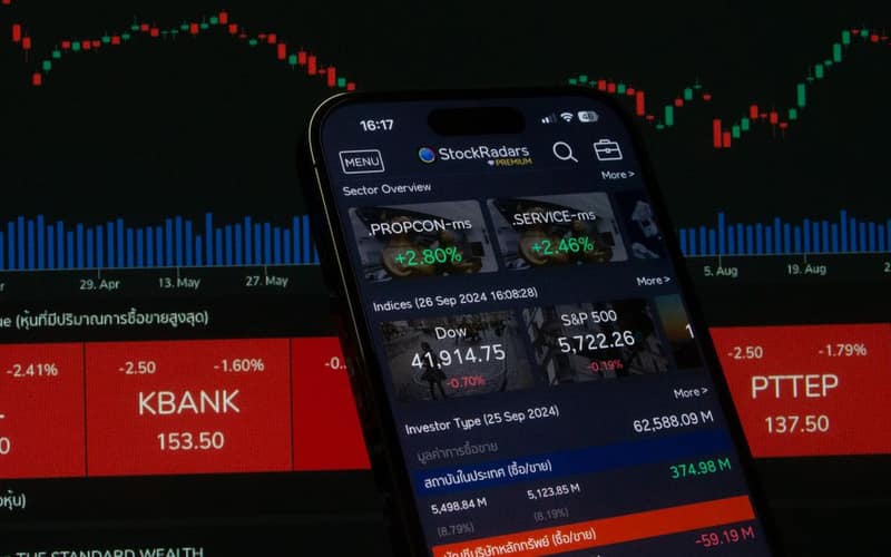 Close-up of a digital stock trading app interface with investment charts and market trends displayed.