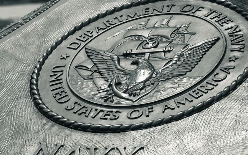Detailed view of the United States Navy emblem on a monument in Washington D.C., showcasing naval heritage.