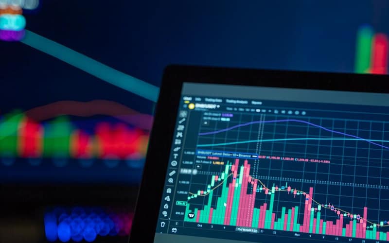 Colorful trading charts showing cryptocurrency market trends on a computer screen.