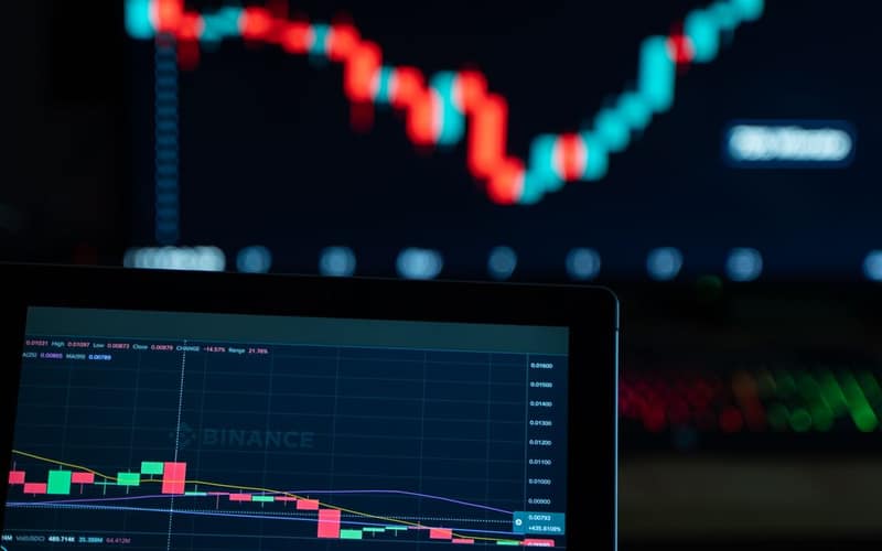 Detailed view of cryptocurrency trading charts on digital screens, showcasing market fluctuations.