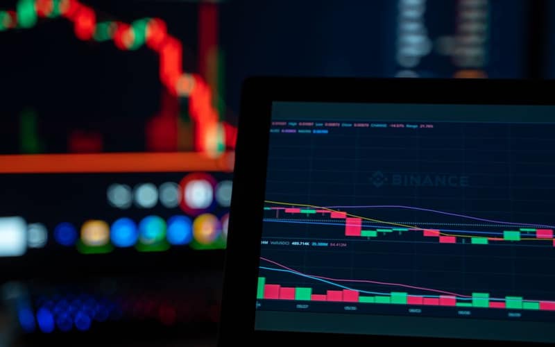 Bright trading screens depict cryptocurrency market trends in a tech setup.