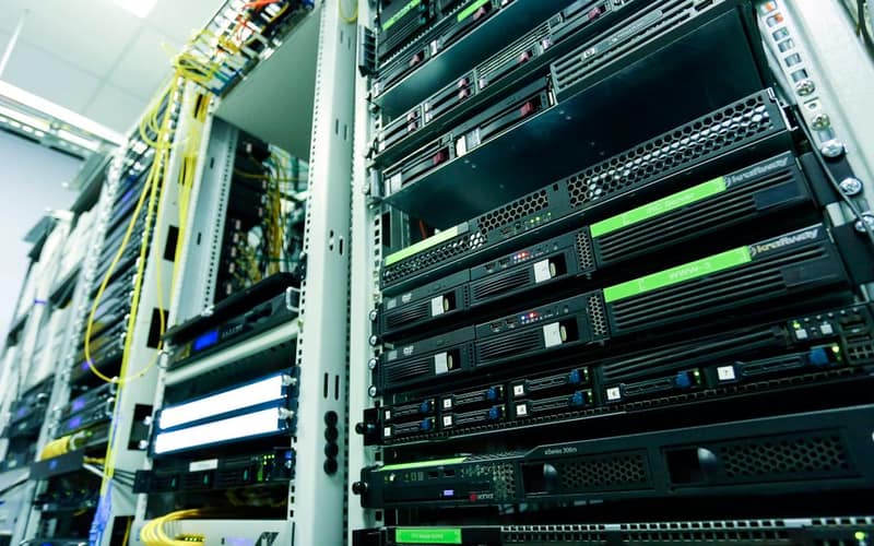 High-tech server rack in a secure data center with network cables and hardware components.