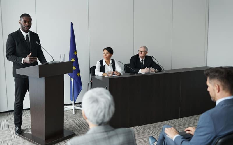 Business presentation featuring a diverse group of professionals discussing at a conference.