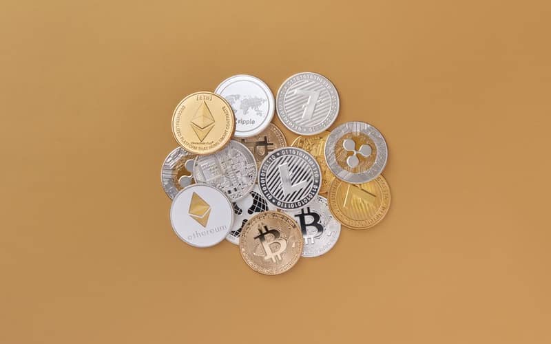 A cluster of cryptocurrencies including Bitcoin, Ethereum on a subtle background symbolizing digital finance.
